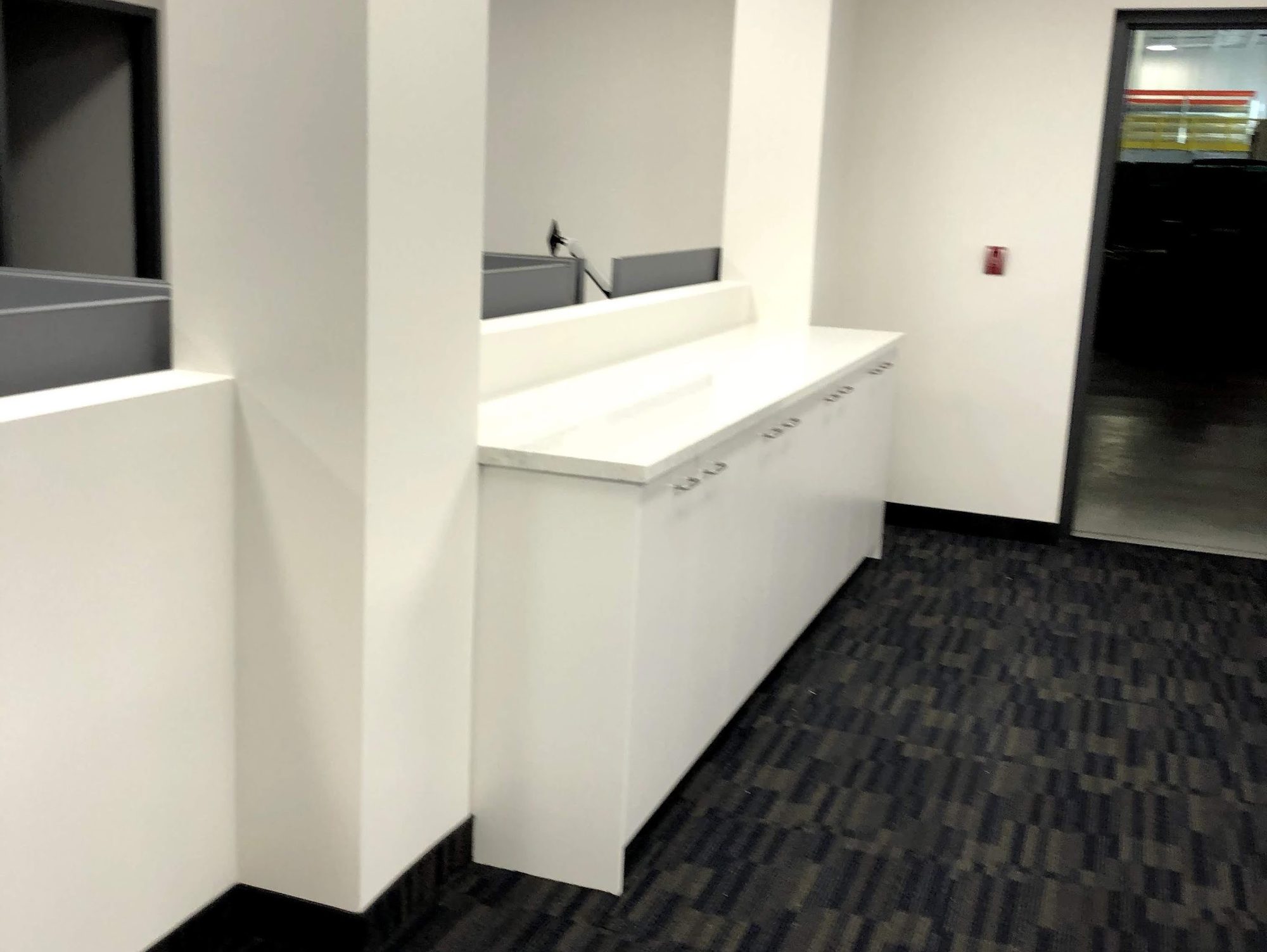 An office kitchenette counter and carpet after cleaning